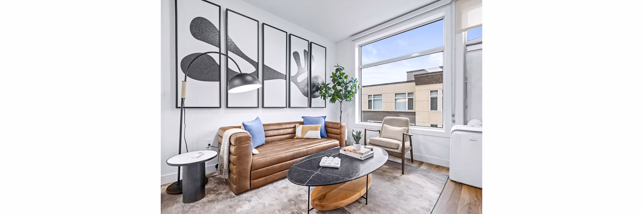 Spacious living room with contemporary decor at The Bristol at Southport Apartments