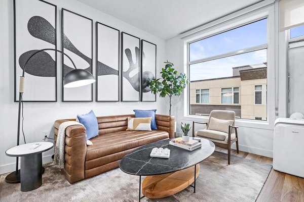 Spacious living room with contemporary decor at The Bristol at Southport Apartments