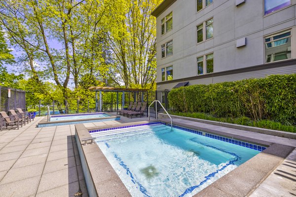 Relaxing poolside area at The Bristol at Southport Apartments, ideal for luxury living experiences