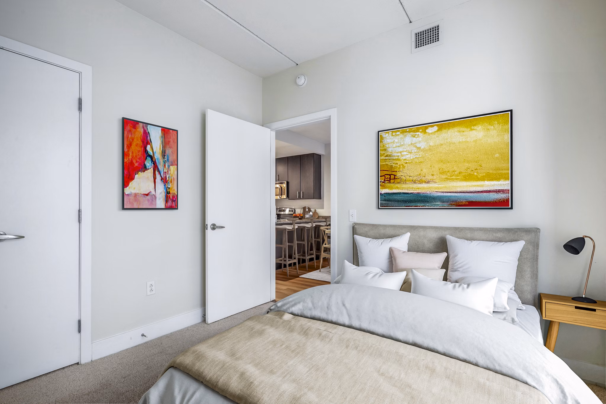 Elegant bedroom with large windows and modern decor at AQ Rittenhouse Apartments, luxury living in a prime location