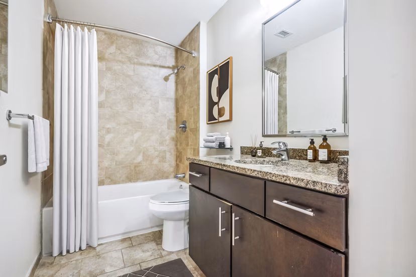 Bathroom featuring modern fixtures and elegant tilework at AQ Rittenhouse Apartments