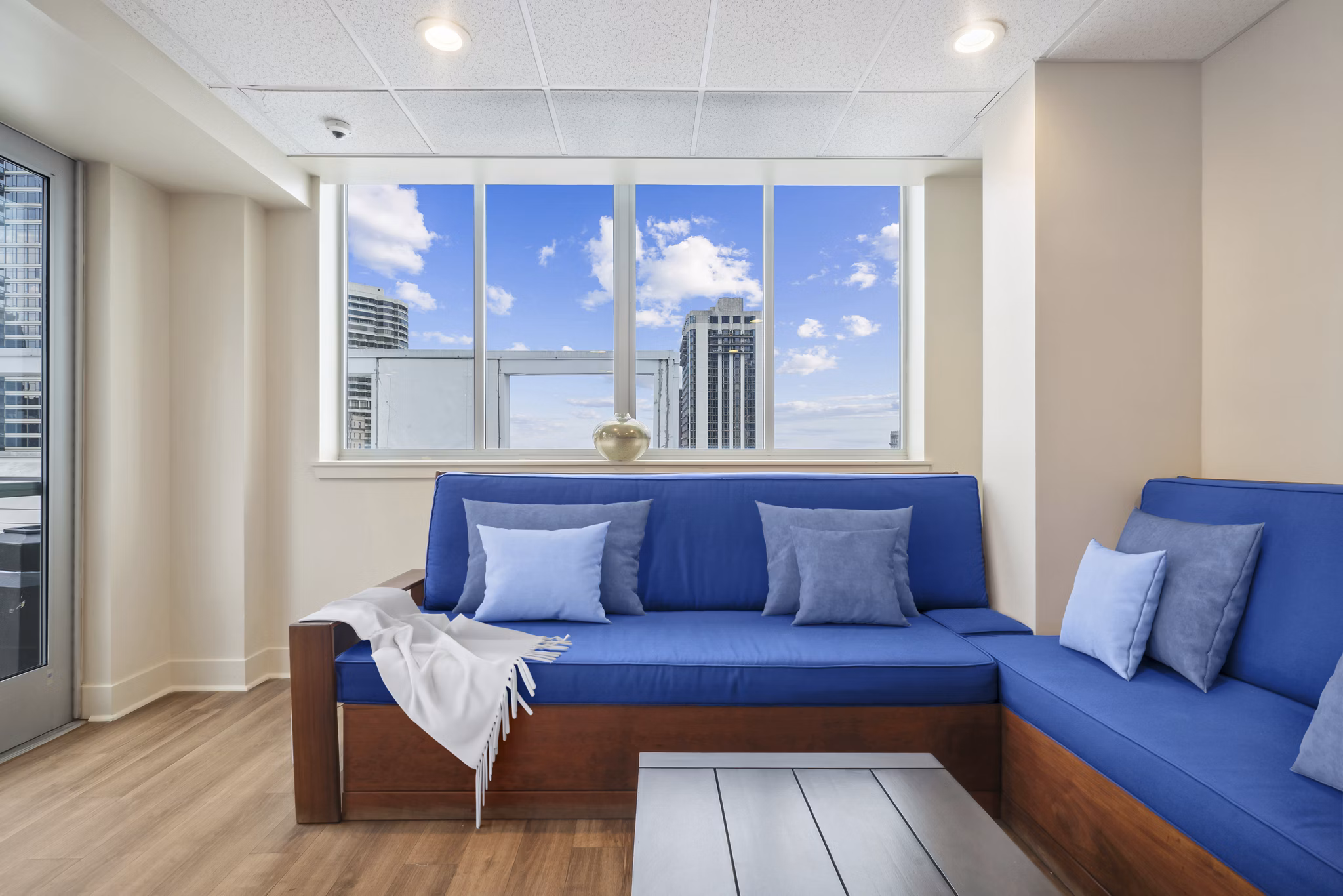 Modern clubhouse with lounge seating and flat-screen TVs at AQ Rittenhouse Apartments, ideal for socializing and relaxation