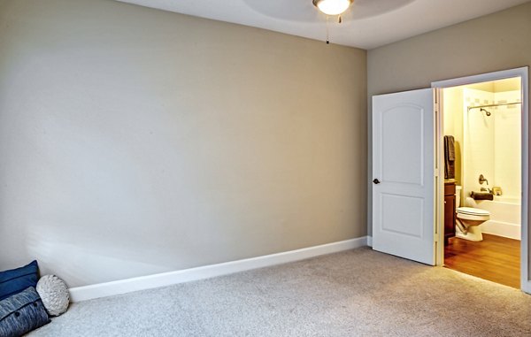 Bedroom with modern decor and plush bedding at Retreat at the Woodlands Apartments, offering comfort and style in a luxury living environment
