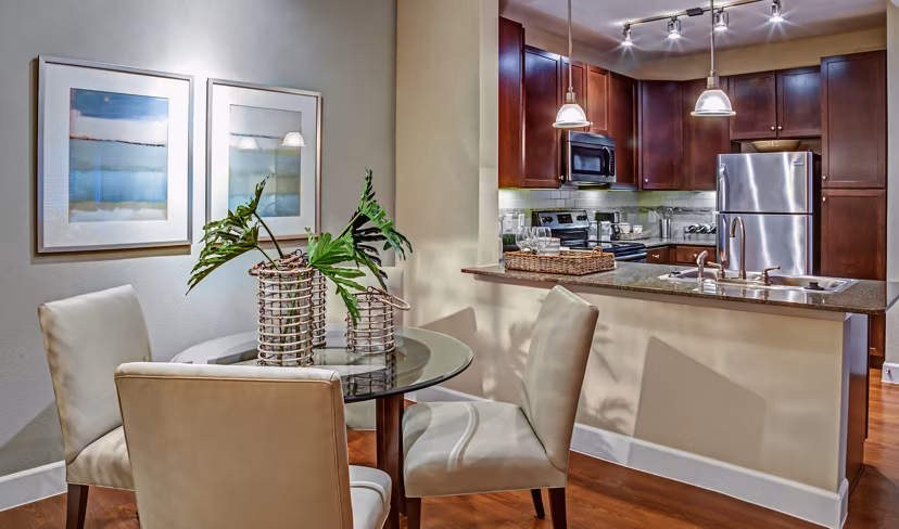 Elegant dining room with modern furnishings at Retreat at the Woodlands Apartments, featuring stylish dÃ©cor and ample natural light