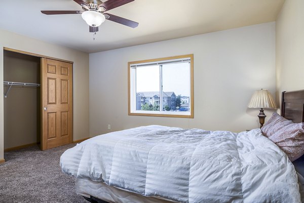 Cozy bedroom with elegant decor at Plantation at Hunters Run Apartments, featuring luxury finishes and natural lighting