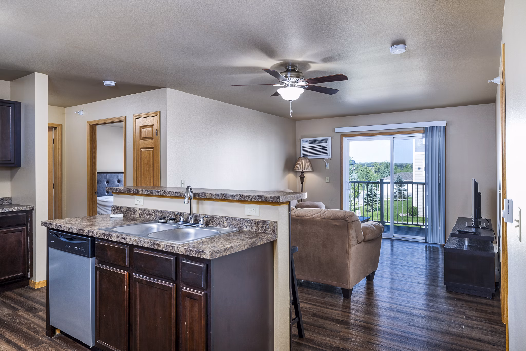 Modern kitchen featuring stainless steel appliances and granite countertops at Plantation at Hunters Run Apartments