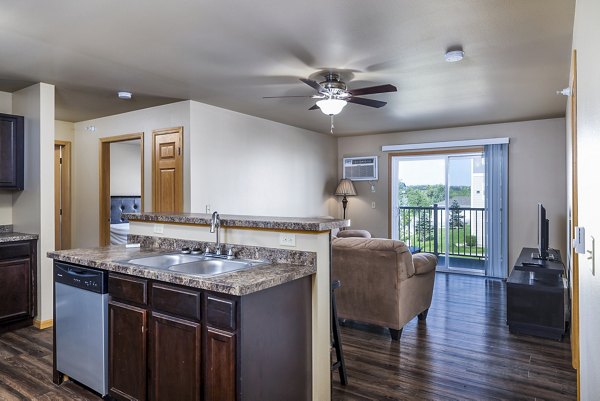 Modern kitchen featuring stainless steel appliances and granite countertops at Plantation at Hunters Run Apartments