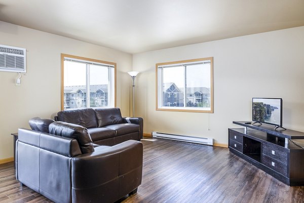 Spacious living room with modern decor at Plantation at Hunters Run Apartments