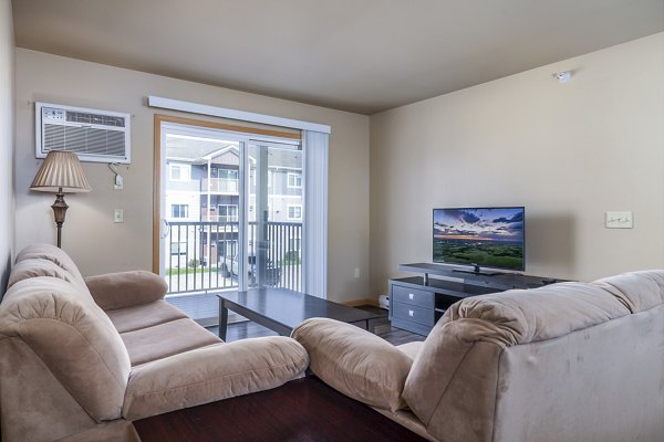 Modern living room with plush seating at Plantation at Hunters Run Apartments, offering luxury lifestyle amenities in a premium location