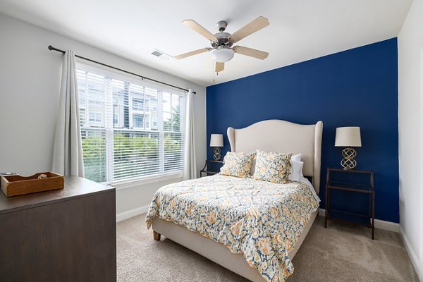 Cozy bedroom with modern decor and ample natural light at Parkside Place Apartments
