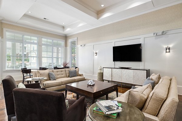 Clubhouse with modern design featuring lounge seating and large-screen TV at Parkside Place Apartments, ideal for social gatherings and relaxation