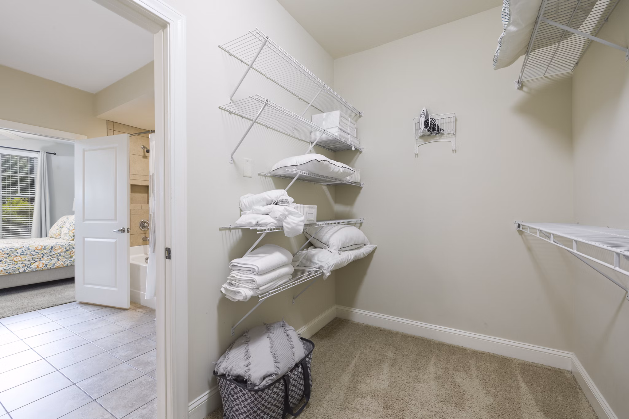 Walk-in closet featuring built-in shelves at Parkside Place Apartments
