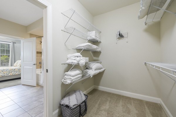 Walk-in closet featuring built-in shelves at Parkside Place Apartments