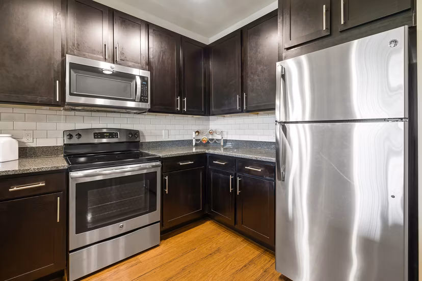 Modern kitchen with stainless steel appliances at Parkside Place Apartments