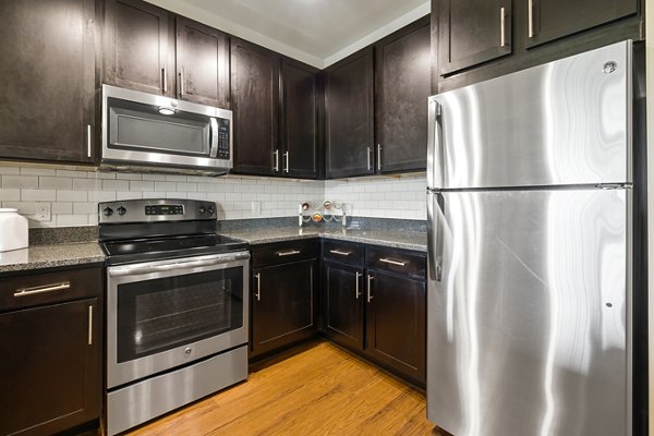 Modern kitchen with stainless steel appliances at Parkside Place Apartments