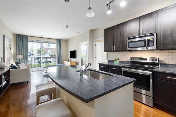Stylish kitchen with marble countertops and stainless steel appliances in Parkside Place Apartments