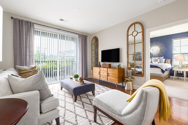 Spacious living room with chic decor and large windows at Parkside Place Apartments