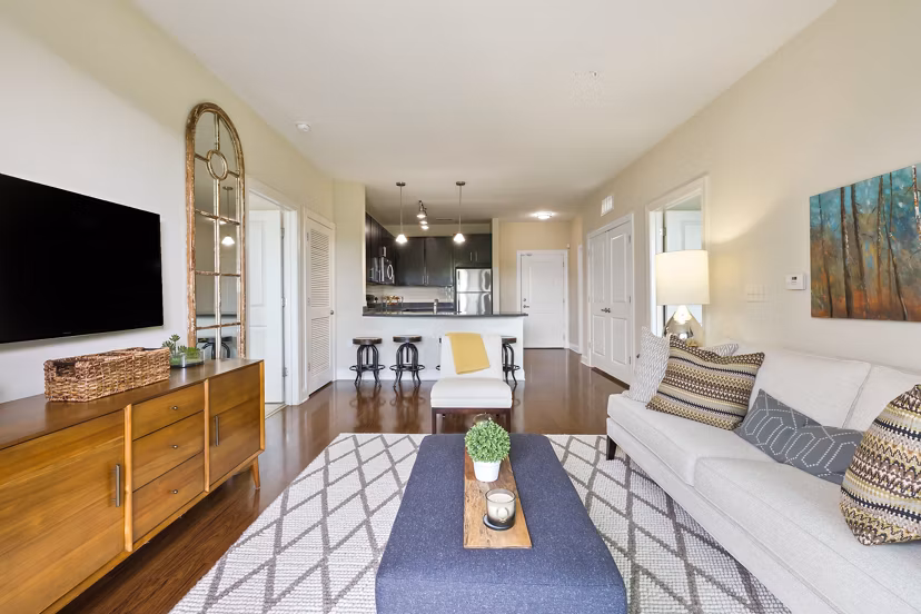 Modern living room at Parkside Place Apartments featuring elegant furnishings and large windows for natural light