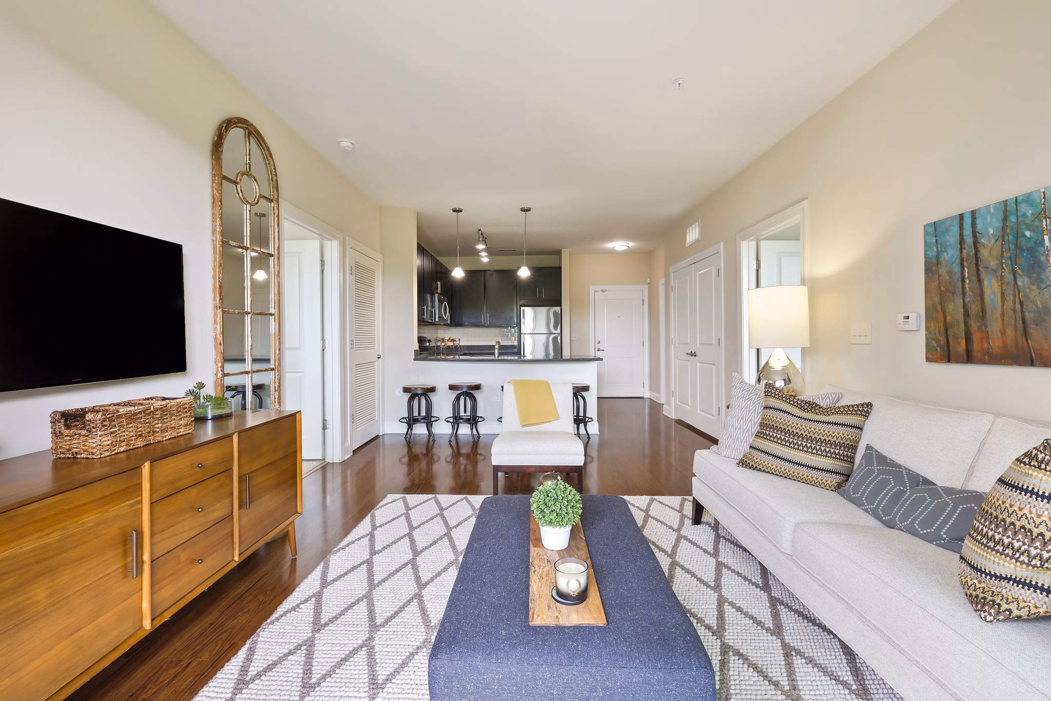 Modern living room at Parkside Place Apartments featuring elegant furnishings and large windows for natural light