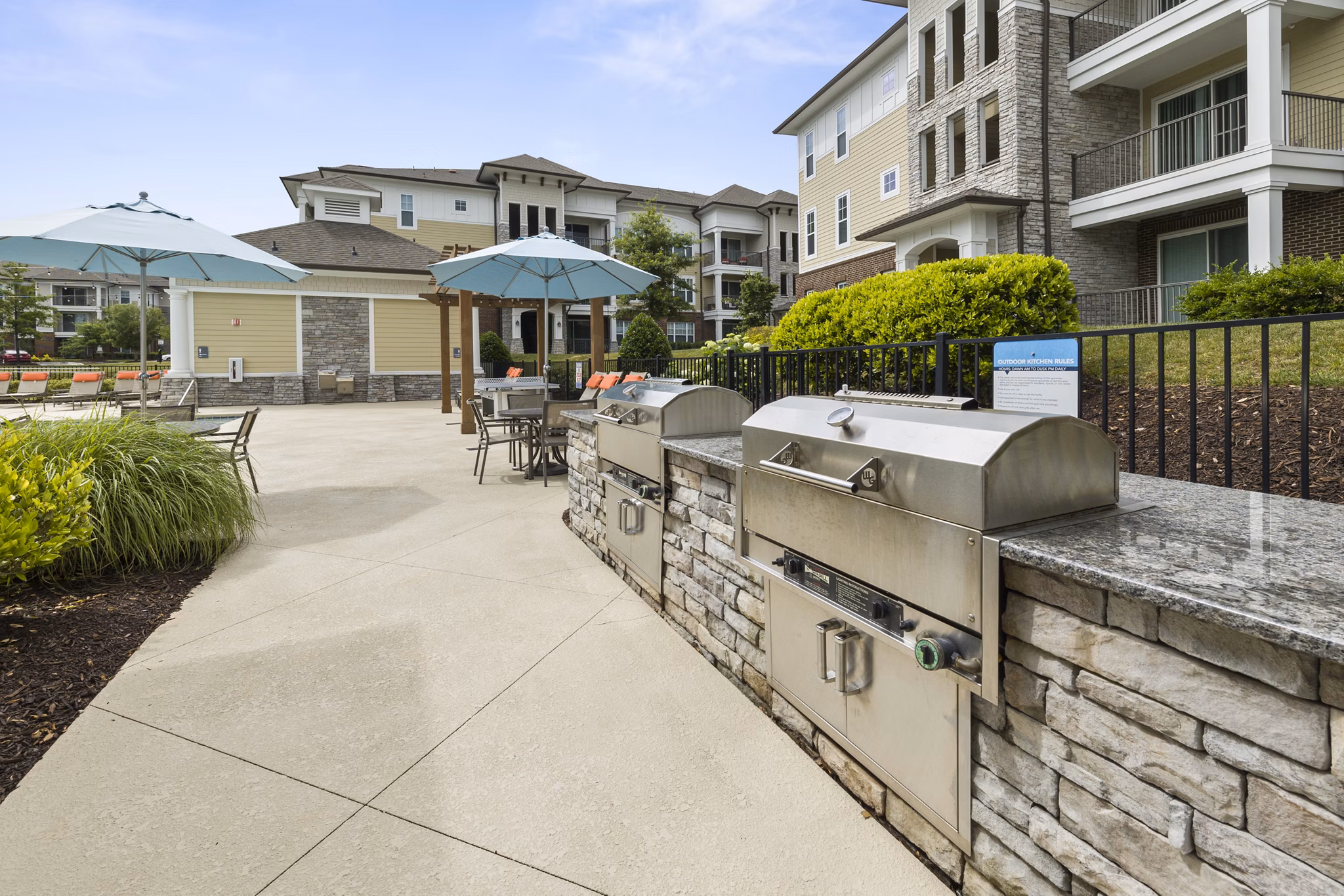 Outdoor grill area with modern seating at Parkside Place Apartments, offering luxury amenities in a vibrant community setting