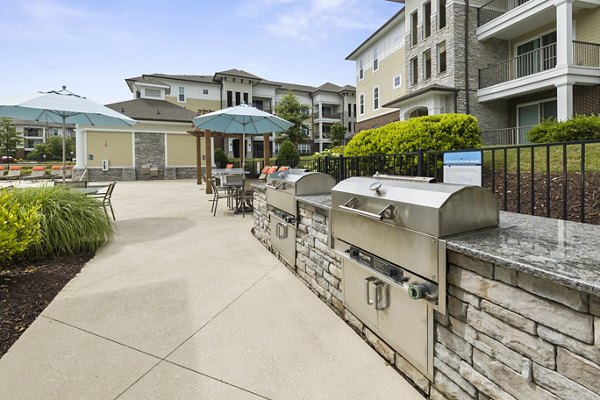 Outdoor grill area with modern seating at Parkside Place Apartments, offering luxury amenities in a vibrant community setting