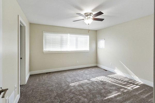 Bedroom featuring modern decor and ample natural light in Creekstone Twin Homes luxury apartments