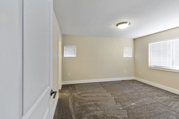 Spacious bedroom with natural light and modern design at Creekstone Twin Homes