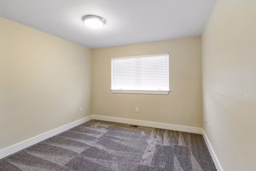 Spacious bedroom with modern furnishings at Creekstone Twin Homes luxury apartments