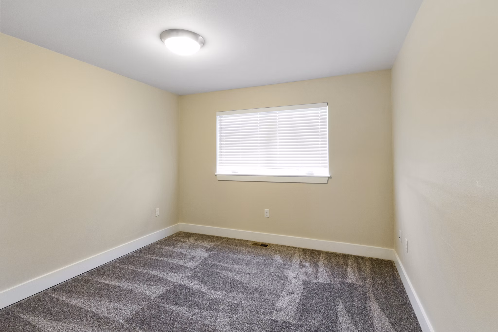 Spacious bedroom with modern furnishings at Creekstone Twin Homes luxury apartments