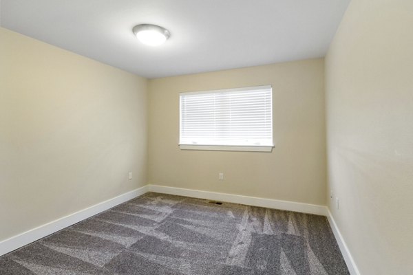 Spacious bedroom with modern furnishings at Creekstone Twin Homes luxury apartments