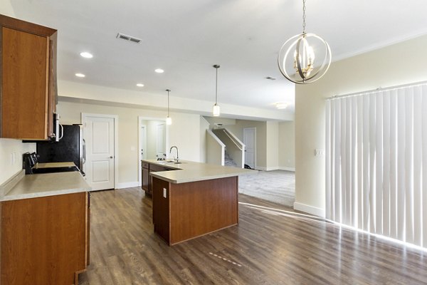Dining area with modern furnishings and elegant lighting in Creekstone Twin Homes apartments