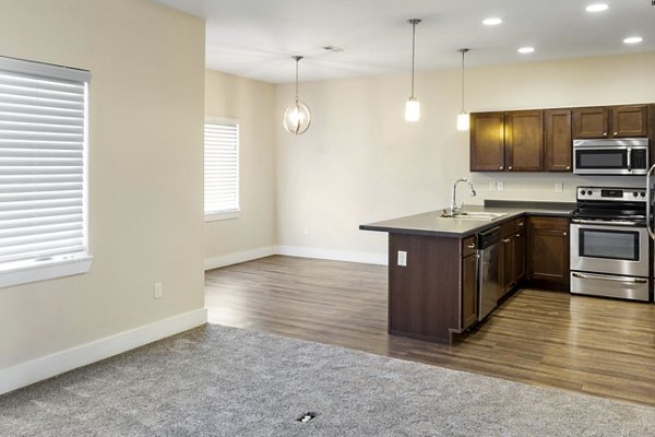 Modern kitchen with stainless steel appliances in Creekstone Twin Homes