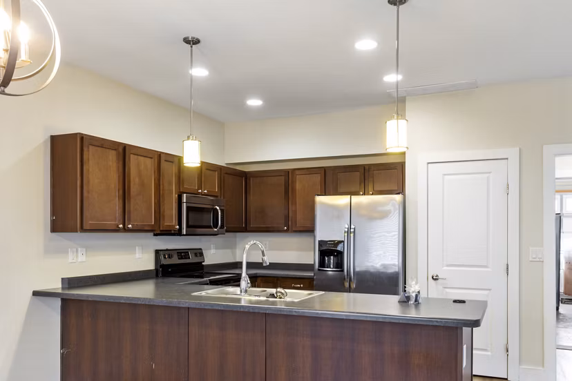 Modern kitchen with stainless steel appliances at Creekstone Twin Homes