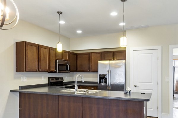 Modern kitchen with stainless steel appliances at Creekstone Twin Homes