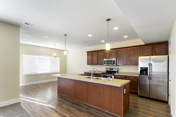 Modern kitchen with stainless steel appliances at Creekstone Twin Homes