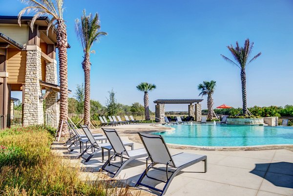 Resort-style pool with lounging area at Dalian Monterrey Village Apartments, providing a luxury experience for residents