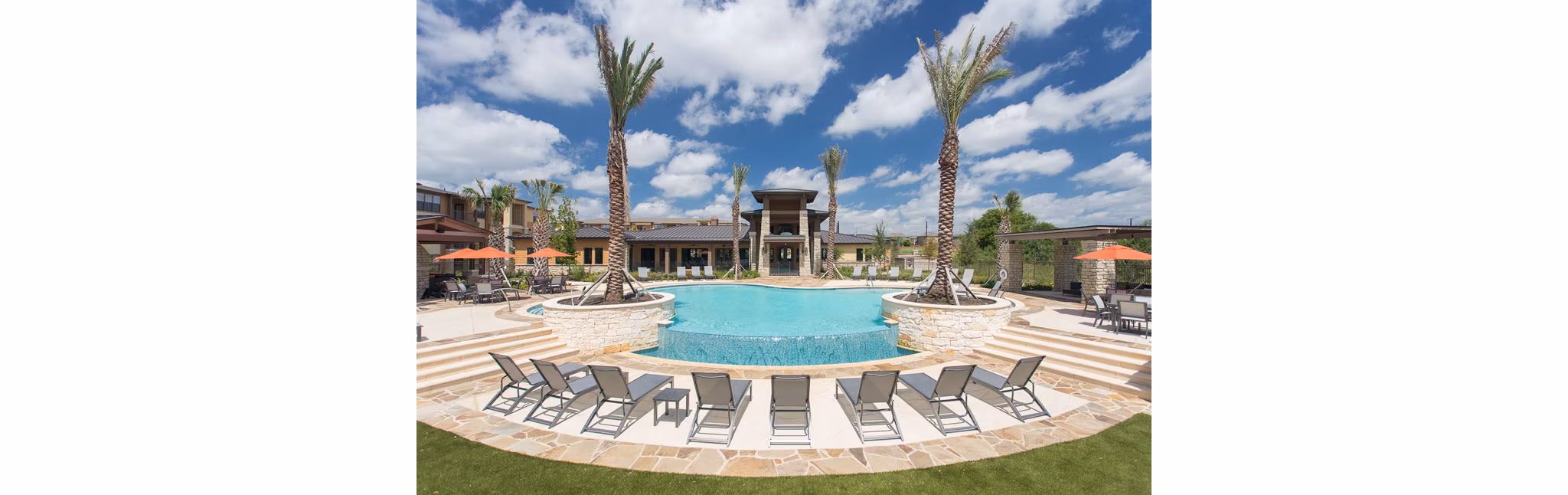 Large outdoor pool at Dalian Monterrey Village Apartments with lounge chairs and landscaping