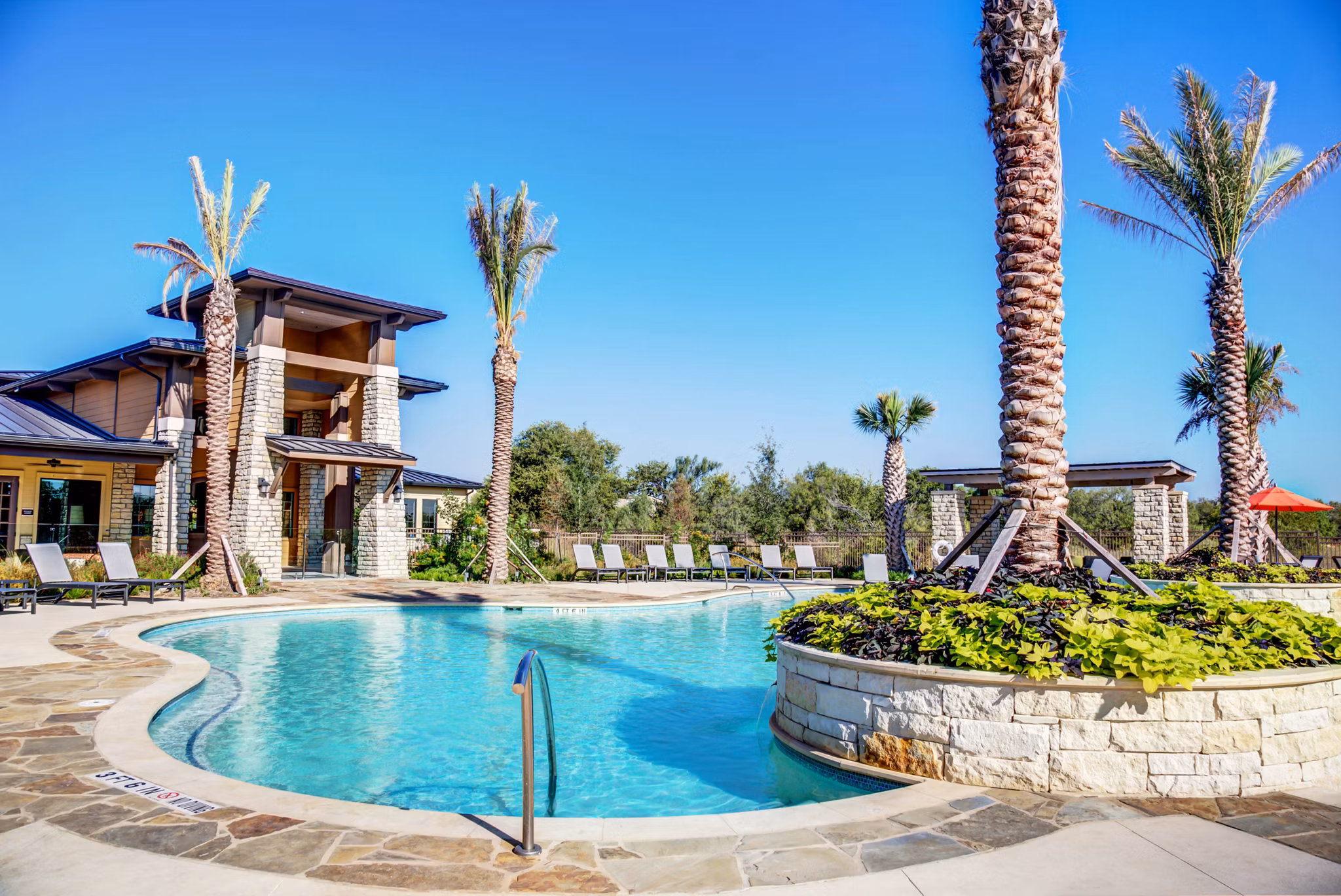 Resort-style pool with sun loungers at Dalian Monterrey Village Apartments