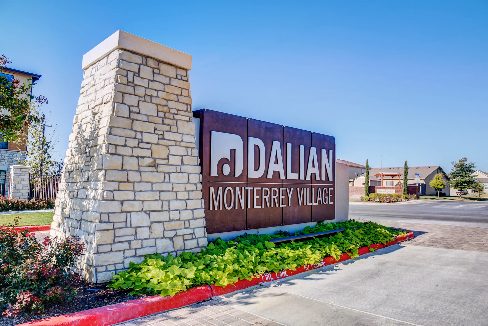 Dalian Monterrey Village Apartments: Signage displaying luxury living at premium community in San Antonio