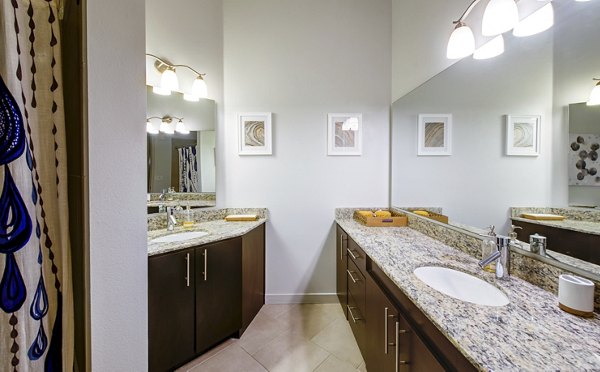 Luxurious bathroom with modern fixtures at Accent Apartments, featuring elegant design and plush amenities for a relaxing experience