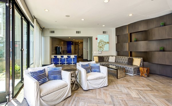 Stylish clubhouse with modern decor at Accent Apartments featuring comfortable seating and entertainment spaces