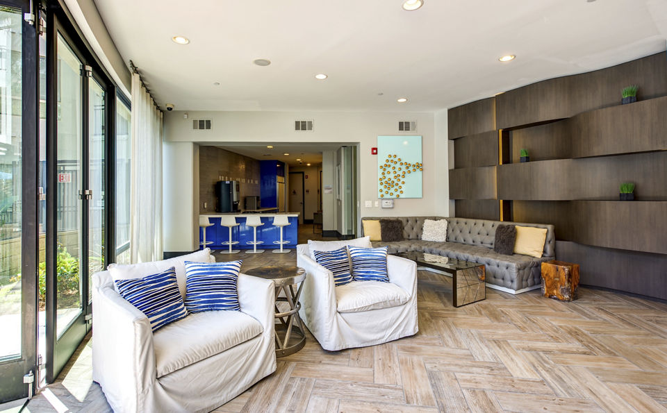 Stylish clubhouse with modern decor at Accent Apartments featuring comfortable seating and entertainment spaces