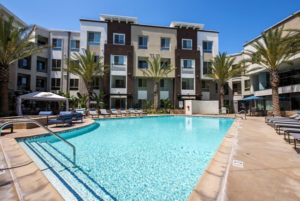 Relaxing pool with lounge chairs at Accent Apartments, offering luxury amenities for residents