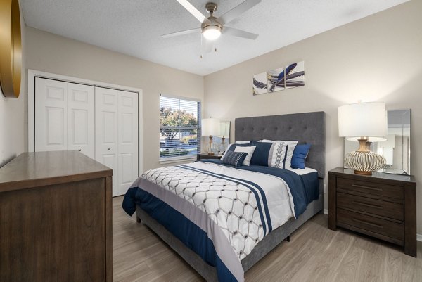 Modern bedroom with elegant decor at The Riley Apartments