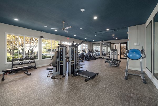 Modern fitness center with advanced equipment at The Riley Apartments