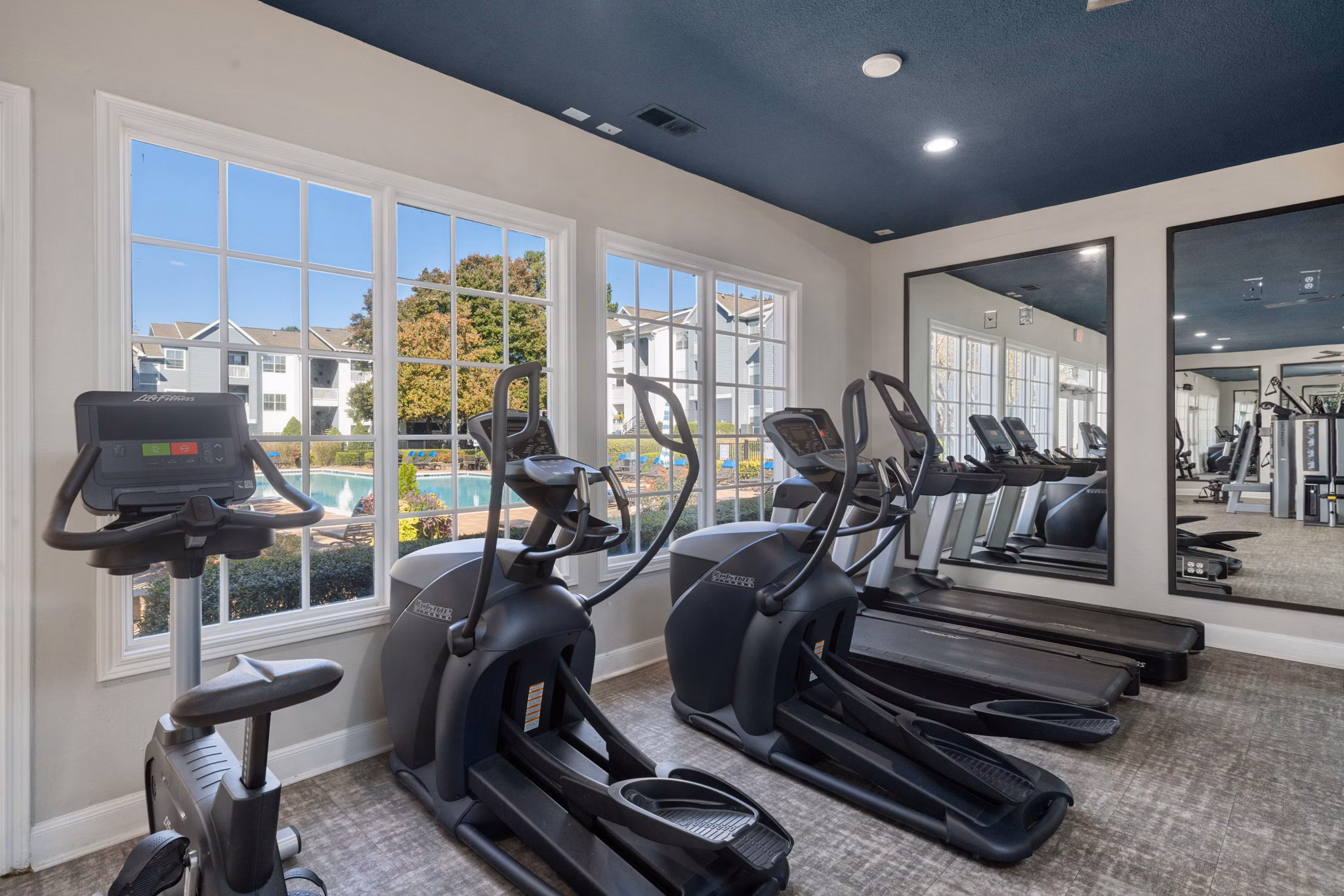 State-of-the-art fitness center with modern equipment at The Riley Apartments for residents seeking an active lifestyle