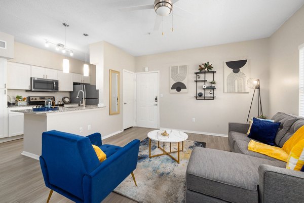 Spacious living room with modern decor at The Riley Apartments in Boston, a luxurious Greystar community