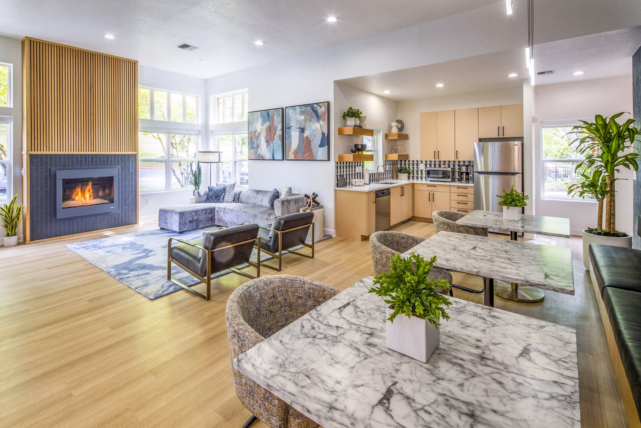 Clubhouse kitchen with modern appliances and island seating at Arbor Heights Apartments