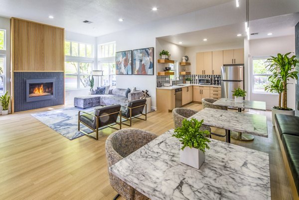Clubhouse kitchen with modern appliances and island seating at Arbor Heights Apartments