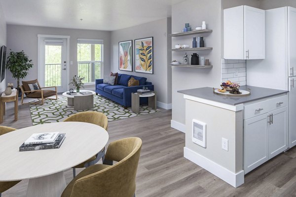 Living room featuring modern furniture and natural light at Arbor Heights Apartments